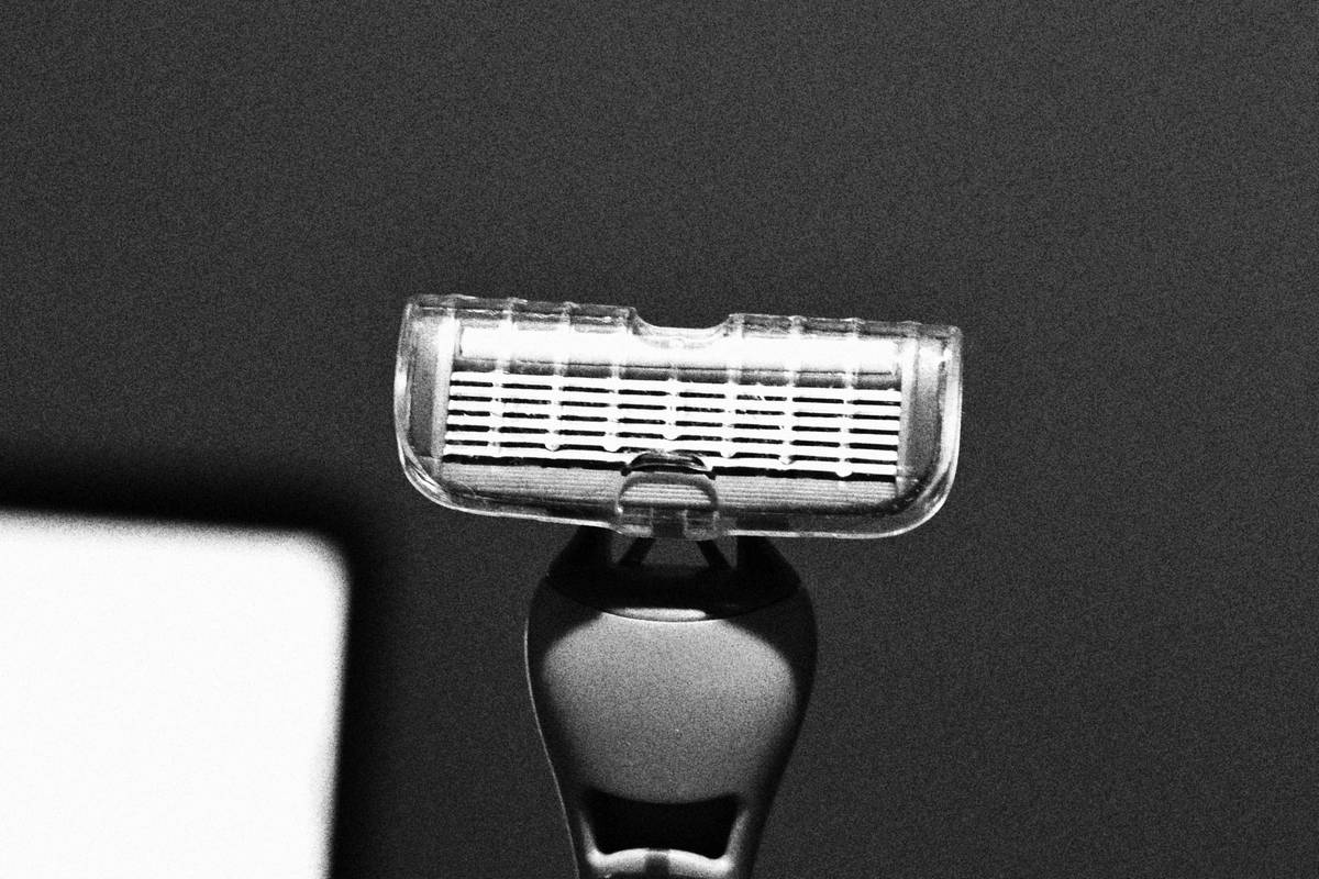 A Labrador retriever before grooming with matted fur and after grooming showing sleek, healthy fur.