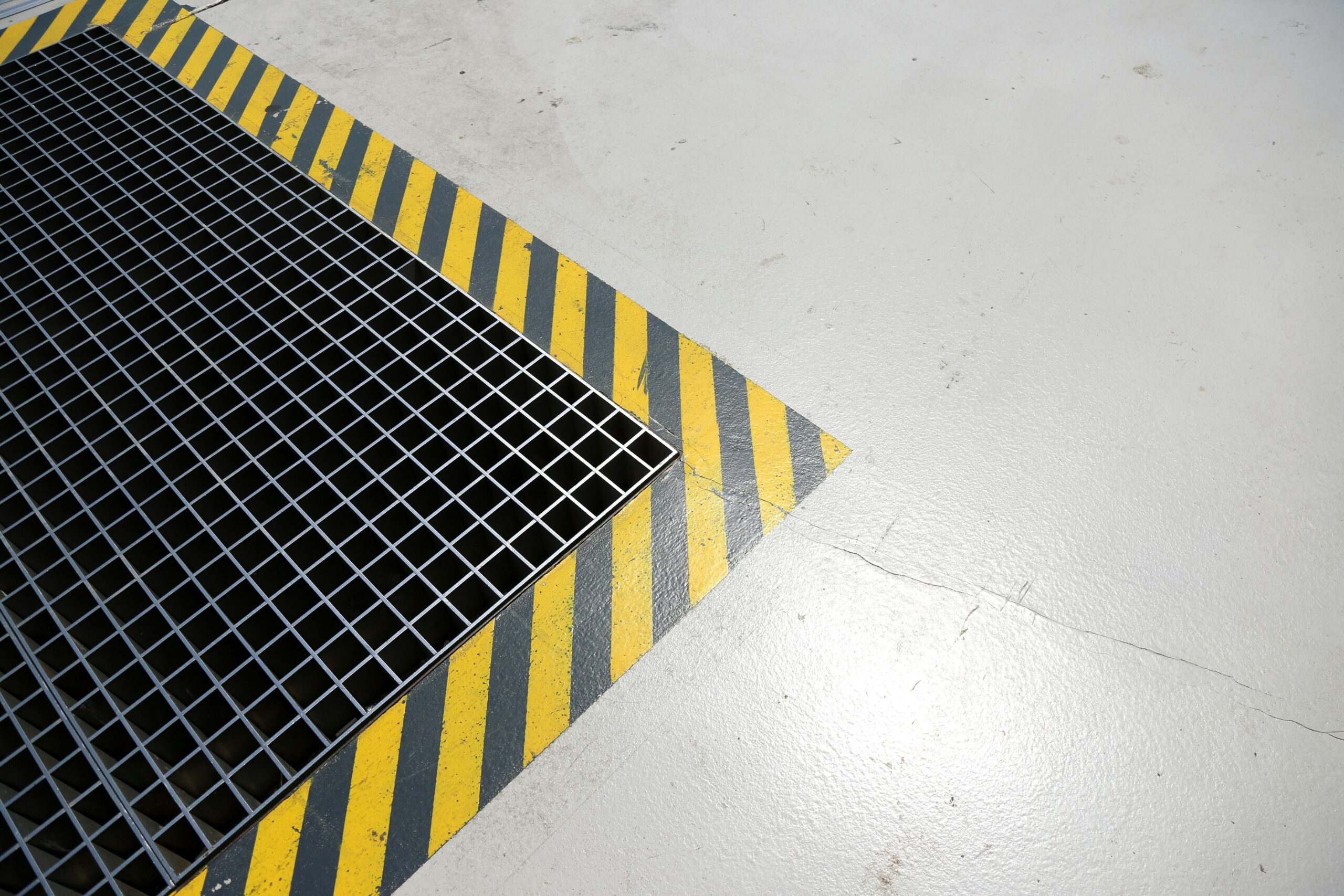 A metal grate sitting on top of a white floor